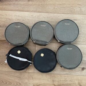 Round gray and black shiseido cosmetic bag